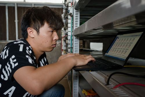 An older ASIC miner sits beside a newer, more efficient model, highlighting the potential for trade-in programs to upgrade mining operations