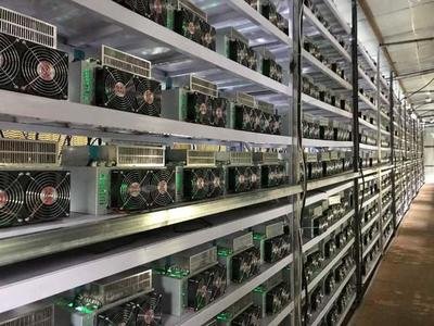 A large-scale mining farm filled with rows of mining rigs, illustrating the power needed for cryptocurrency mining.